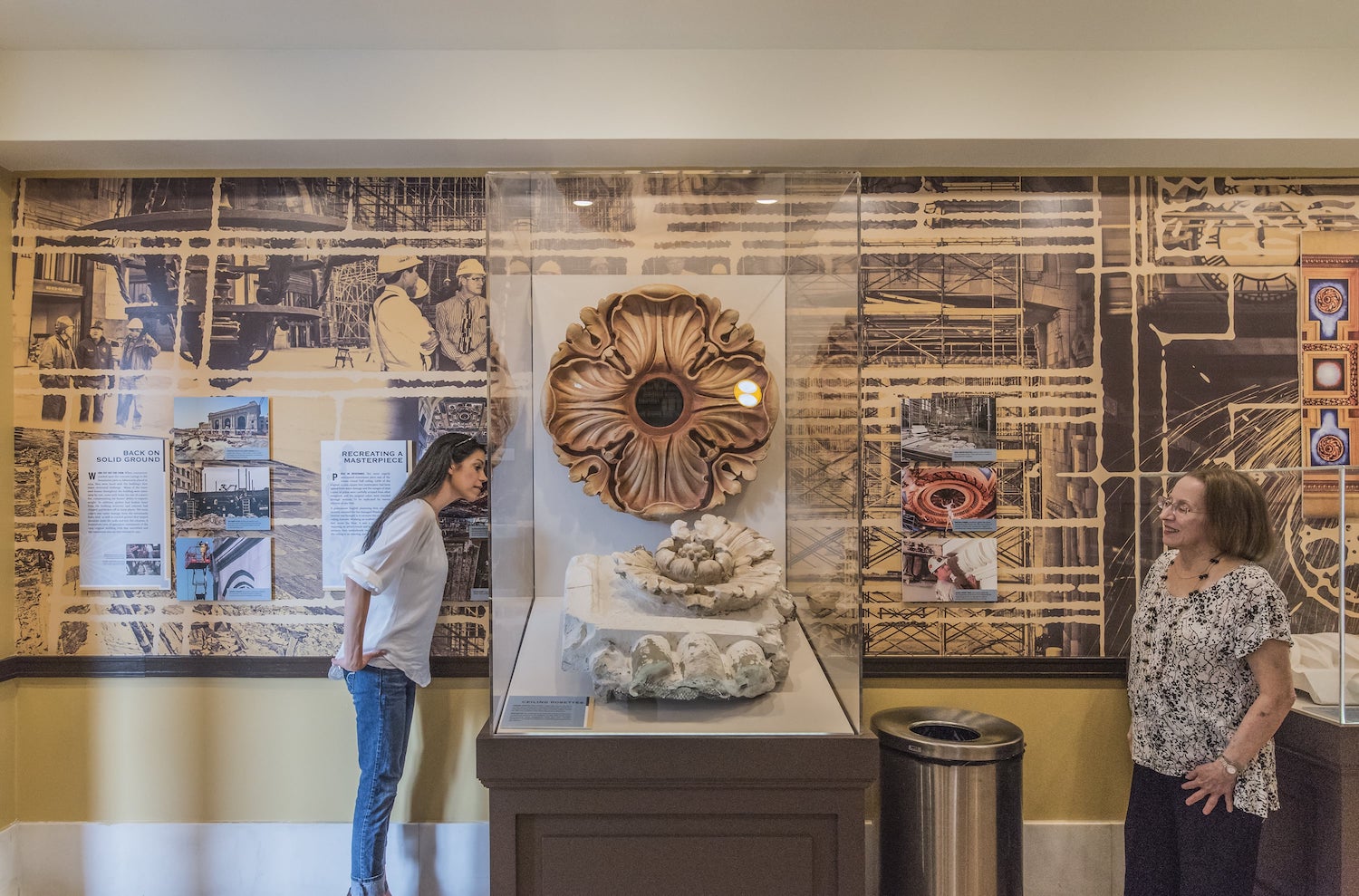 Two guests look at ceiling piece